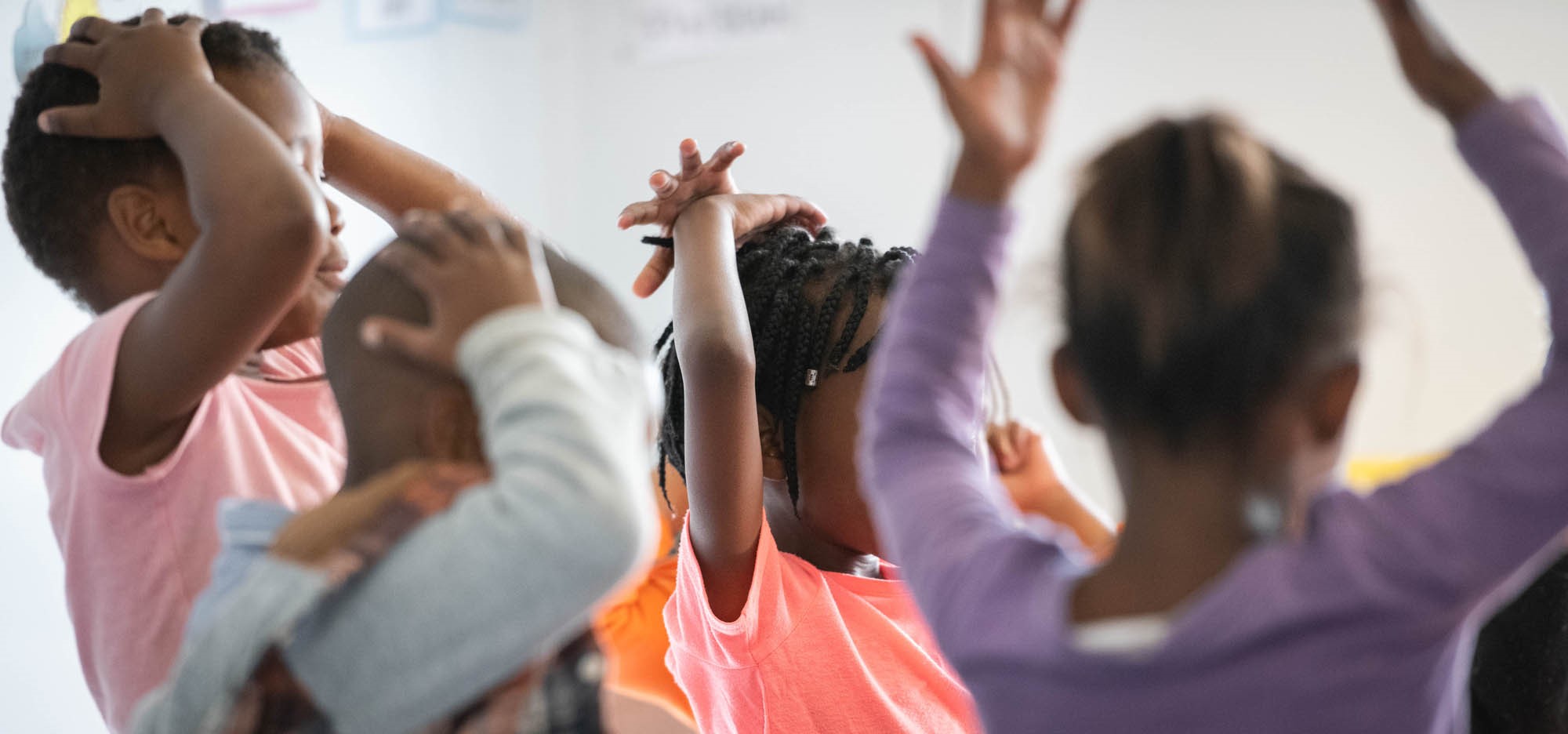 Children playing a game waving their hands in the air